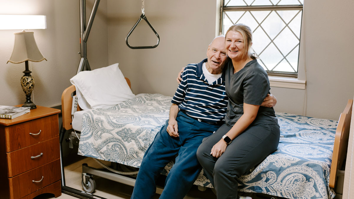 Elder and Staff Member in Patient Room at Conway Healthcare and Rehabilitation Center